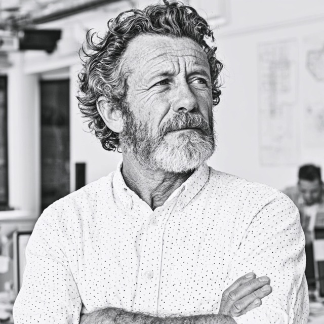 A skeptical client, arms crossed, in a bright office